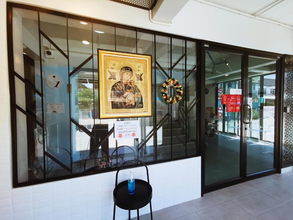 A glass-fronted entrance area displaying religious artwork and seasonal decor.