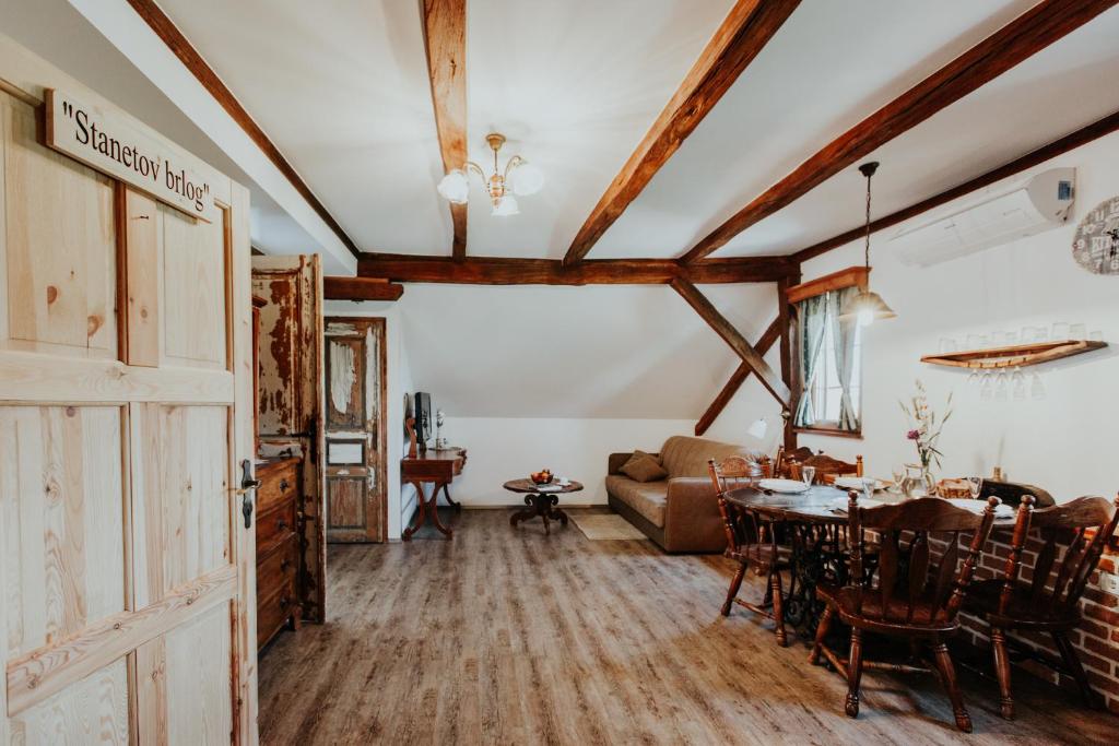 a living room with a table and a couch at RANČ JUREŠ in Ljutomer