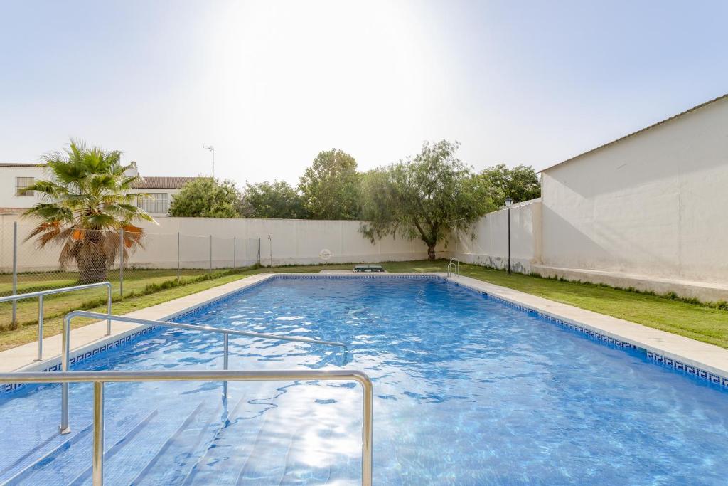 a large swimming pool with blue water at Villa Gallardo in Campillos