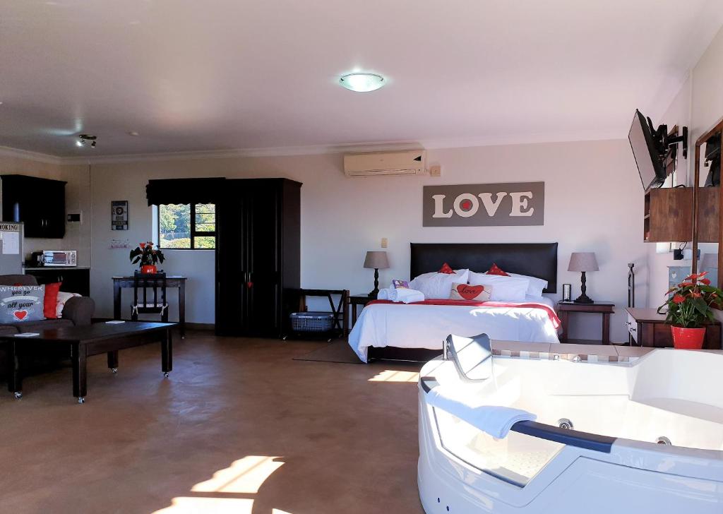 a bedroom with a bed with the word love on the wall at Harmony Haven Couples Retreat in Amanzimtoti