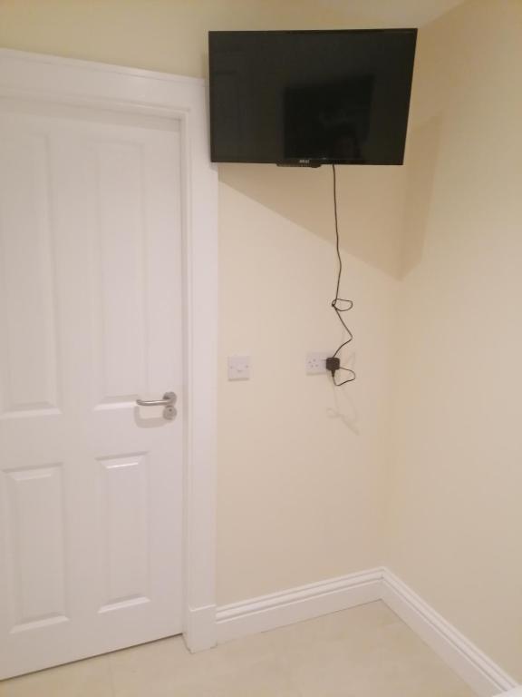 a door with a television hanging on a wall at Inspiration Lodge in Anascaul