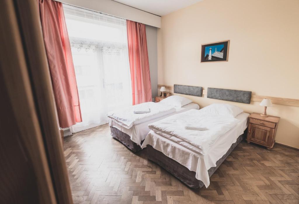Postel nebo postele na pokoji v ubytování Cybulskiego Guest Rooms