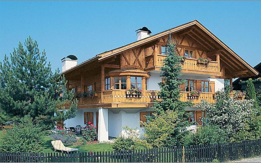 a large wooden house with a balcony at Ferienhaus Rosa 2 & 5 in Füssen