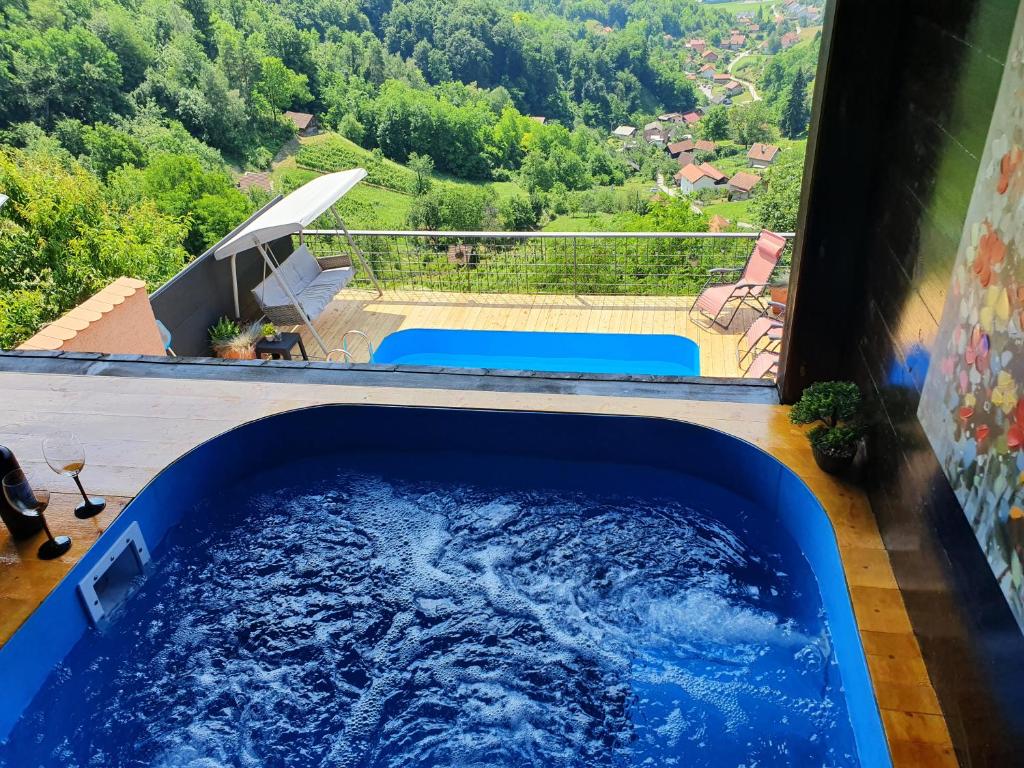 a plunge pool in a house with a view of the mountains at Hygge Hill in Krapinske Toplice