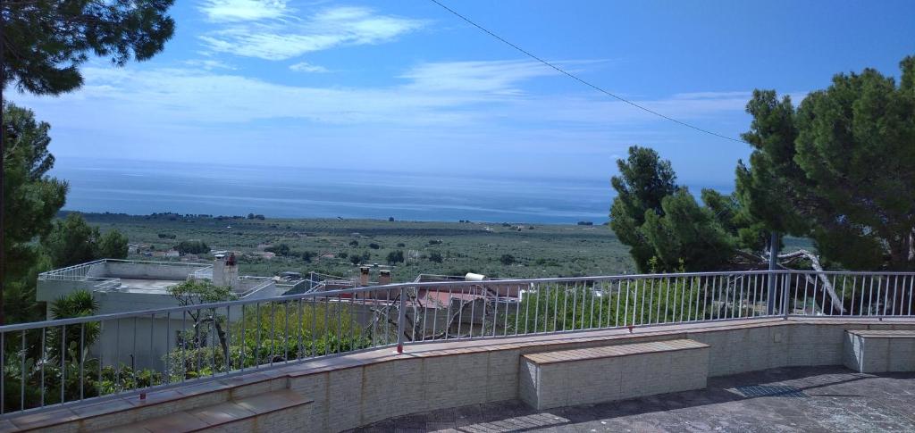 a view of a field from the balcony of a house at La veranda sul golfo in Monte SantʼAngelo