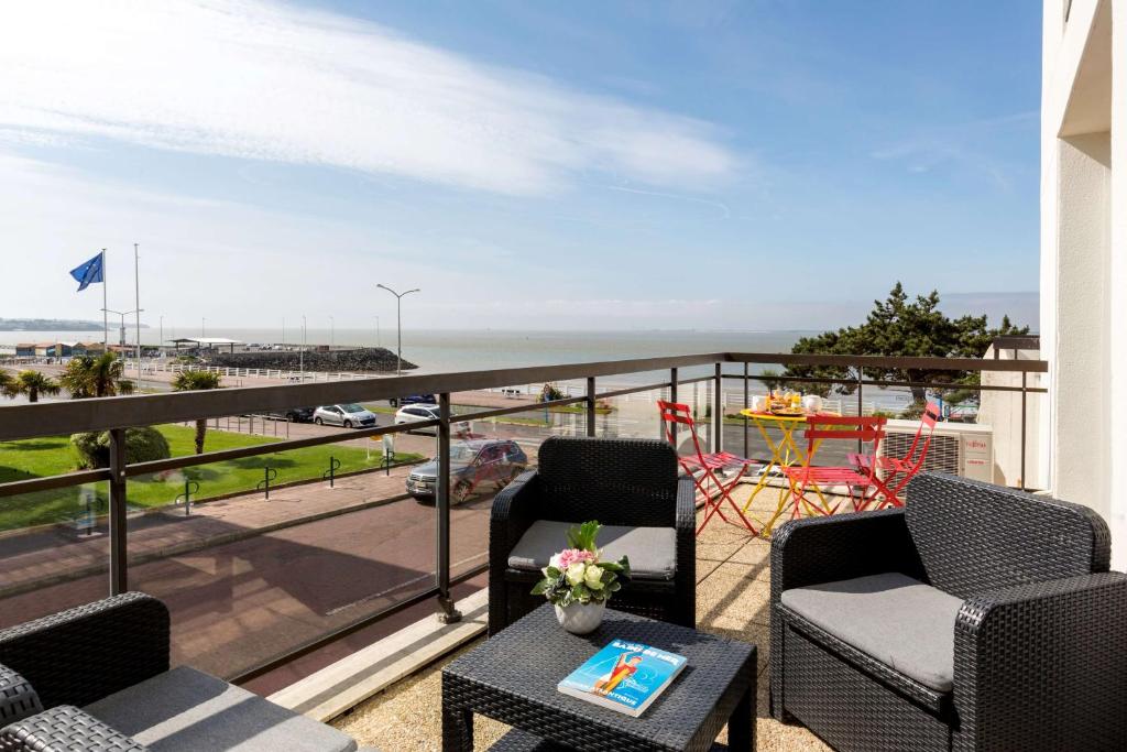 a balcony with chairs and a view of the ocean at Best Western Hôtel Royan Océan in Royan
