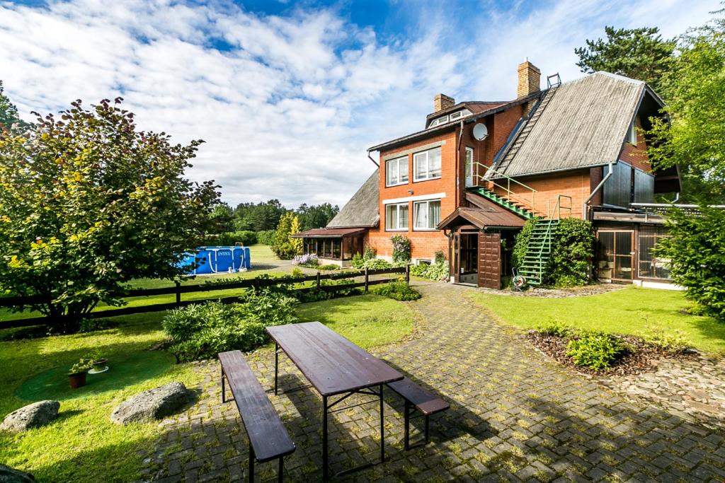 a house with a picnic table in front of it at 200m Sea ENGURE Kr Valdemāra 1 in Engure