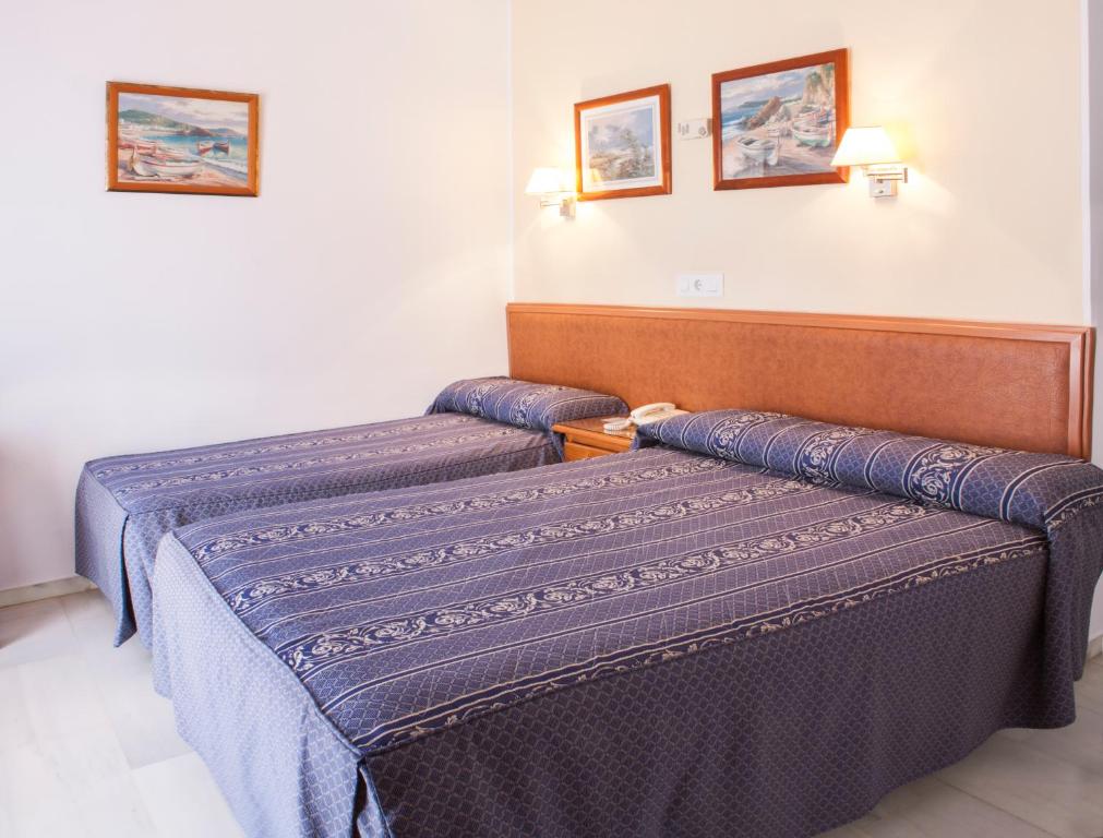 Postel nebo postele na pokoji v ubytování HOTEL GUADALUPE