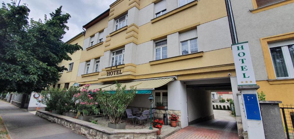 żółty budynek z napisem "hotel" w obiekcie Hotel Baross w Győr