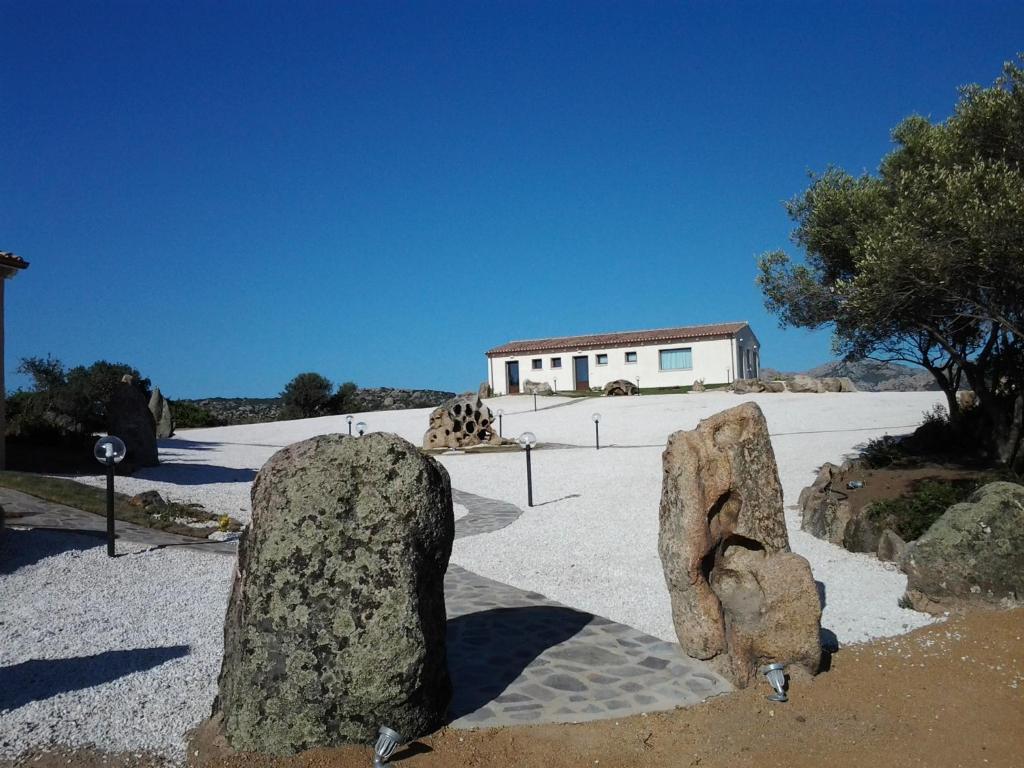 a group of large rocks in a parking lot at B&B Terra e Smeralda in Arzachena