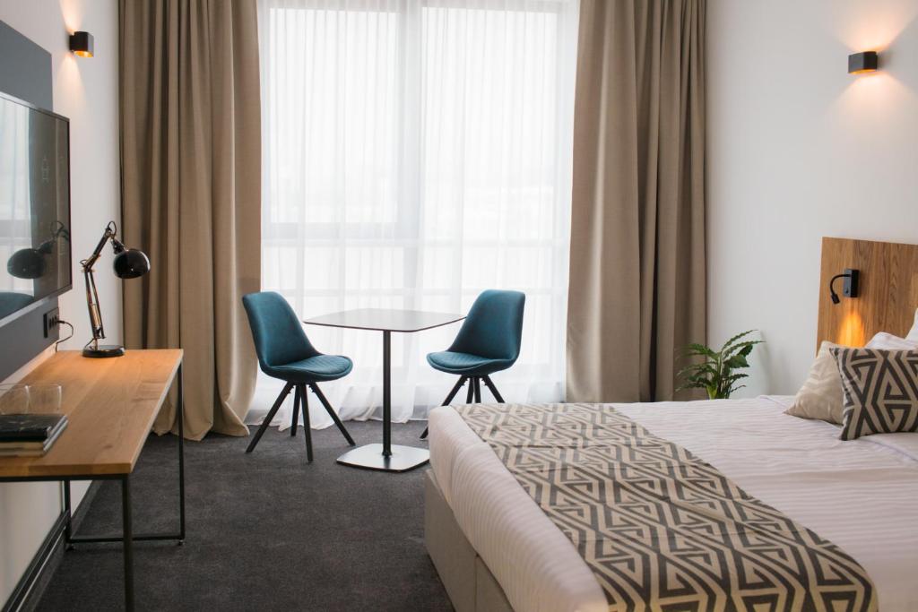 Roko Garni Hotel tesisinde bir odada yatak veya yataklar