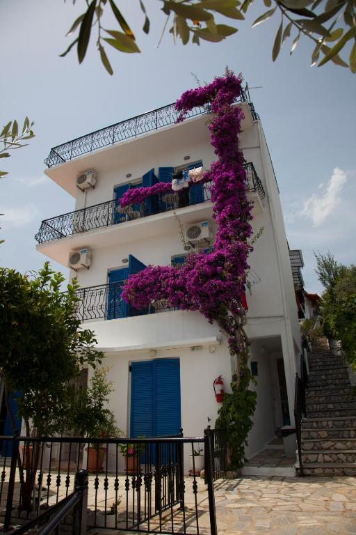 a building with purple flowers on the side of it at Villa Nina Adult only in Skiathos