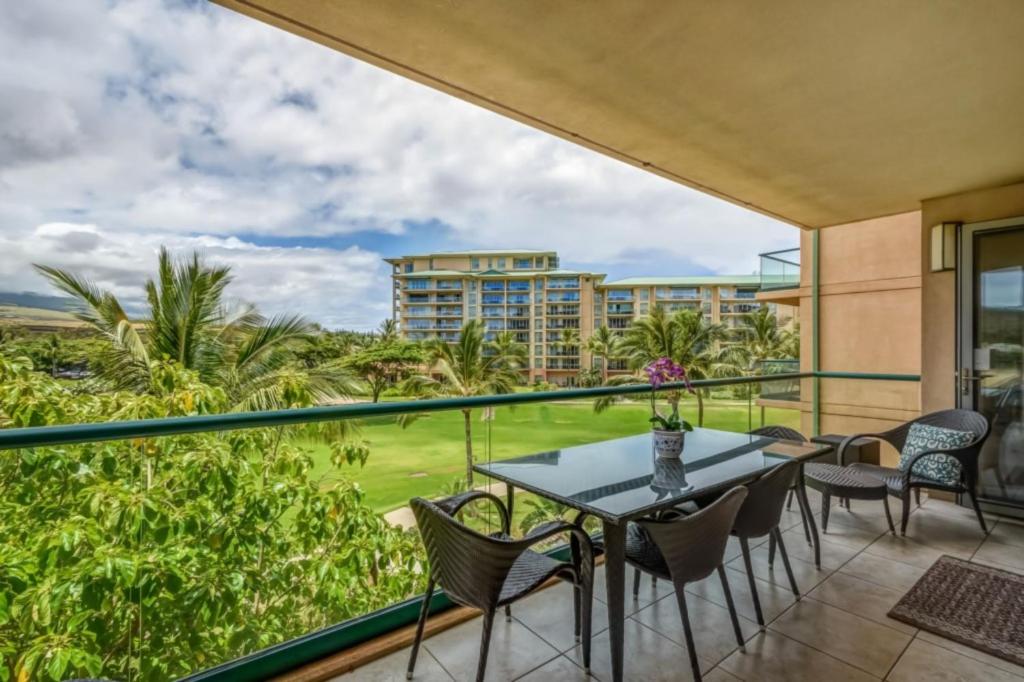 a balcony with a table and chairs and a view at Maui Westside: Honua kai Konea 312/314 in Kaanapali