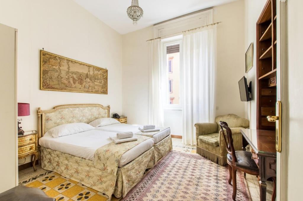 a bedroom with a bed and a chair at Trastevere Decò Apartment in Rome