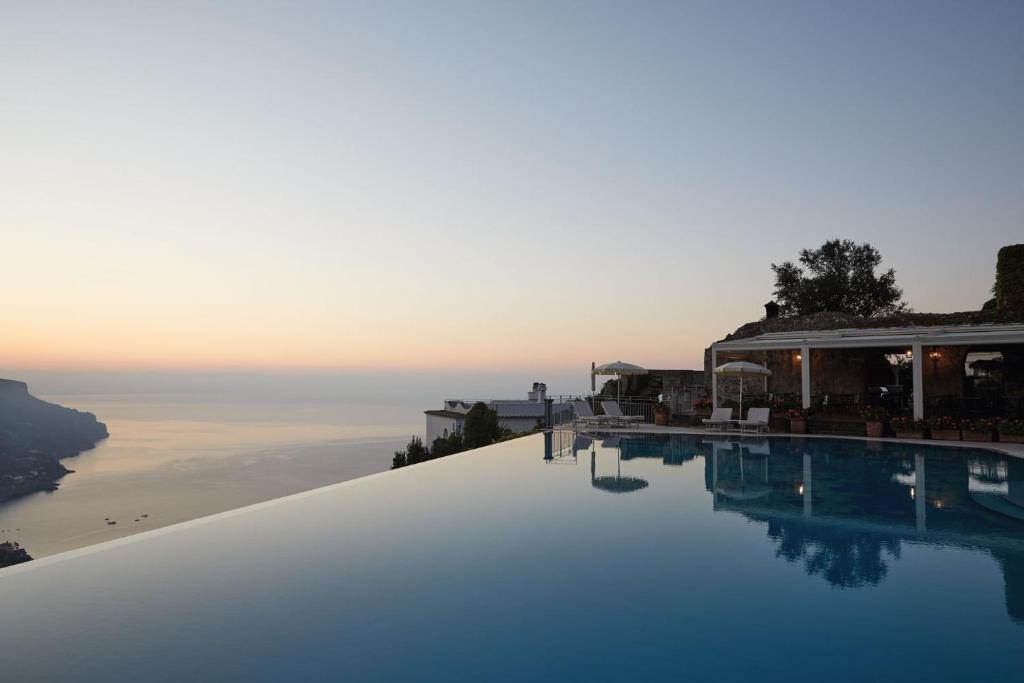 a swimming pool with a view of the water at Caruso, A Belmond Hotel, Amalfi Coast in Ravello