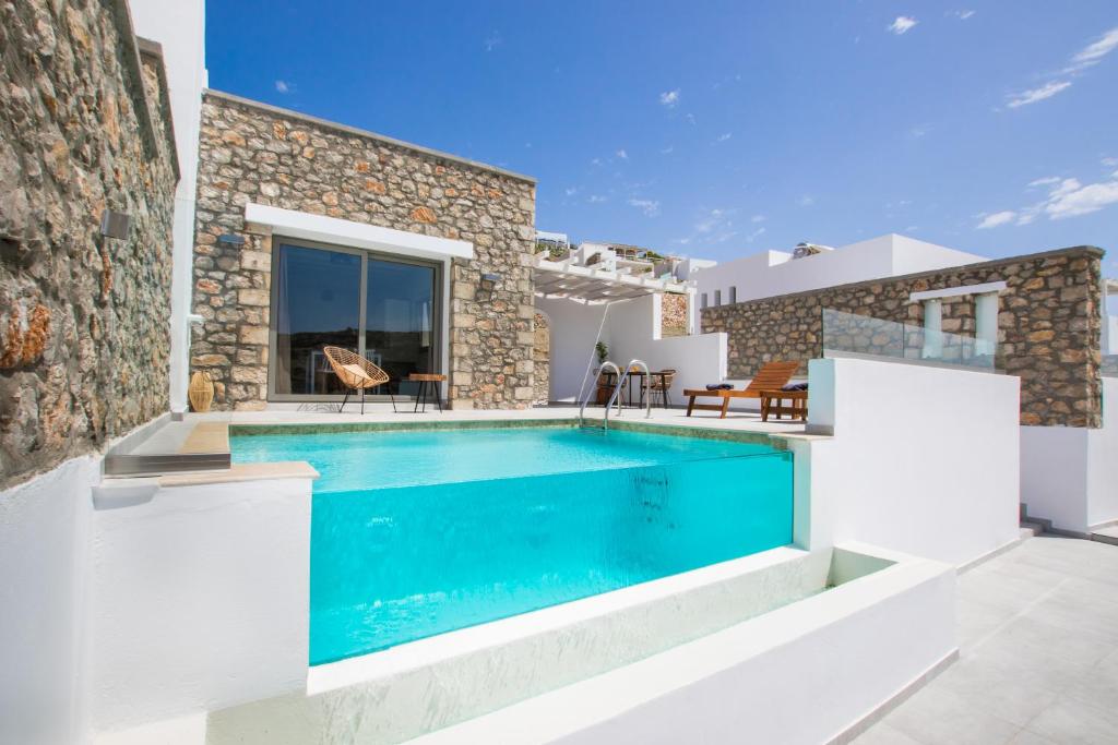 a villa with a swimming pool and a house at CIEL BOUTIQUE VILLAS in Afiartis