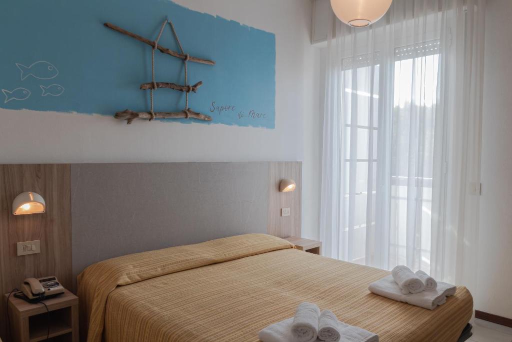 Postel nebo postele na pokoji v ubytování Hotel Astrid