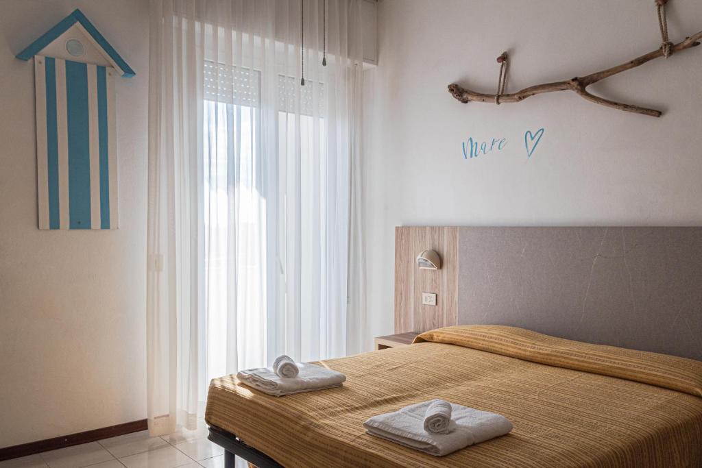 Postel nebo postele na pokoji v ubytování Hotel Astrid