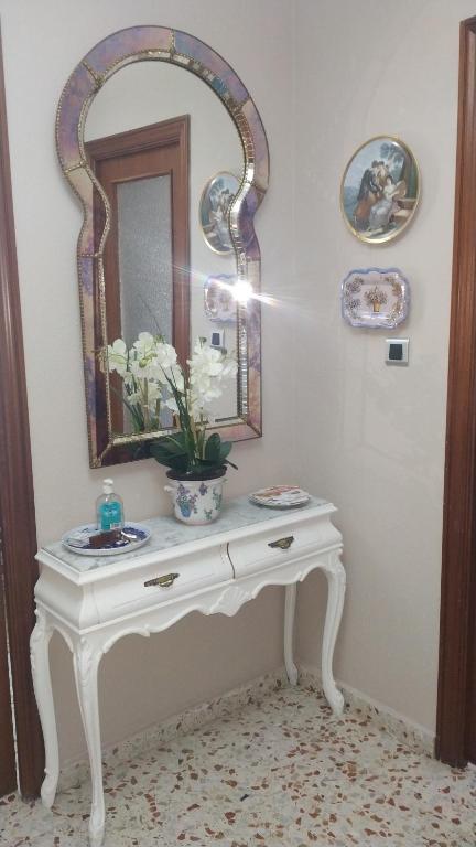 エル・カンページョにあるApartamento Marín El Campelloの白いテーブル(鏡と花瓶付)