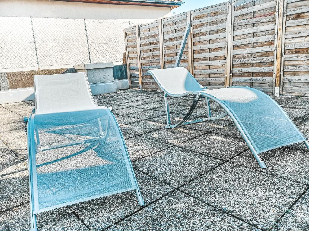 two chairs sitting next to each other on a patio at La Loggia - Appartement Terrasse + Garage à Grenoble in Grenoble