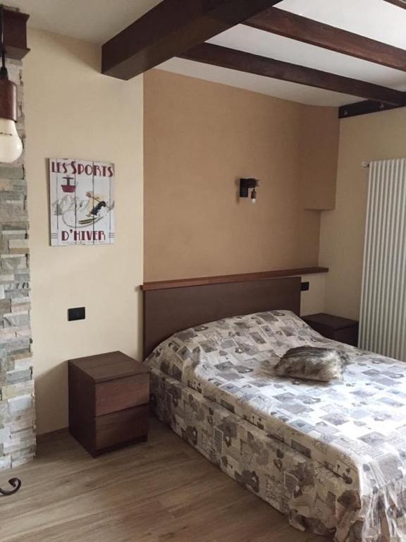 a bedroom with a bed and a sign on the wall at Saint Patrick's INN in Limone Piemonte