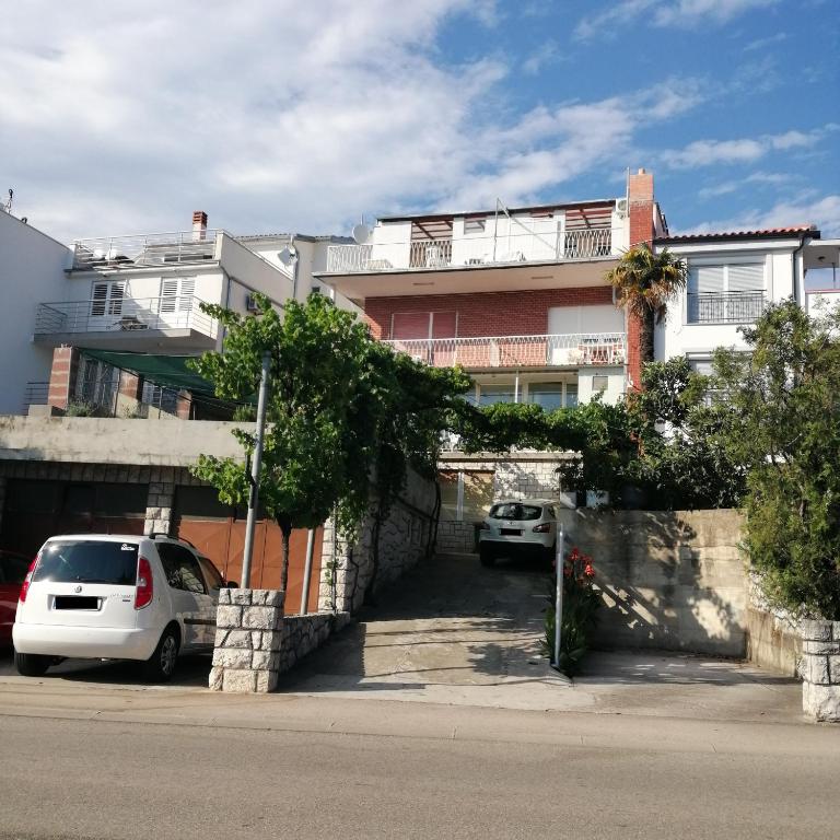 a white car parked in front of a building at Apartmani Marijan in Crikvenica