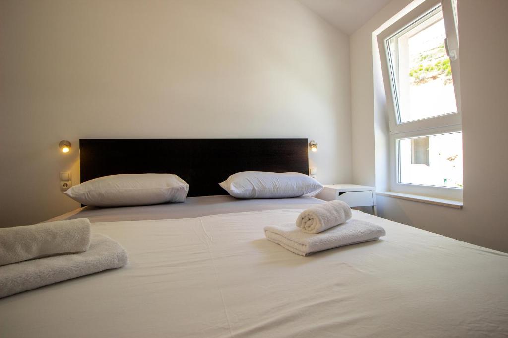 Postel nebo postele na pokoji v ubytování Apartments ZINA