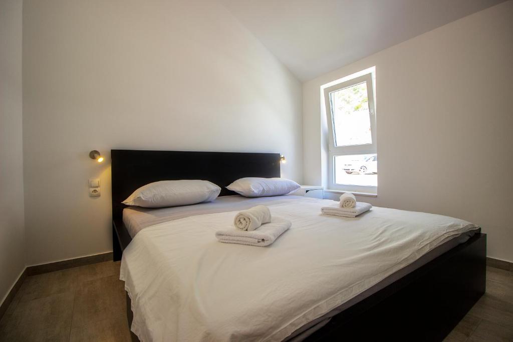 Postel nebo postele na pokoji v ubytování Apartments ZINA