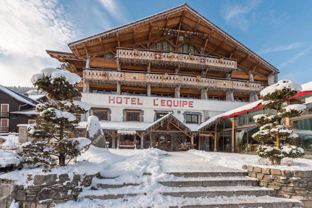 a large hotel with snow on the steps at Hotel L'Equipe in Morzine