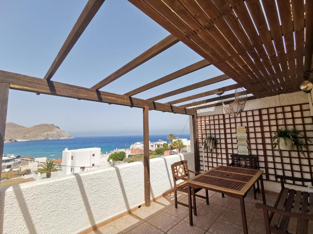 a patio with a table and a view of the ocean at Apartamento paula 2 in Níjar