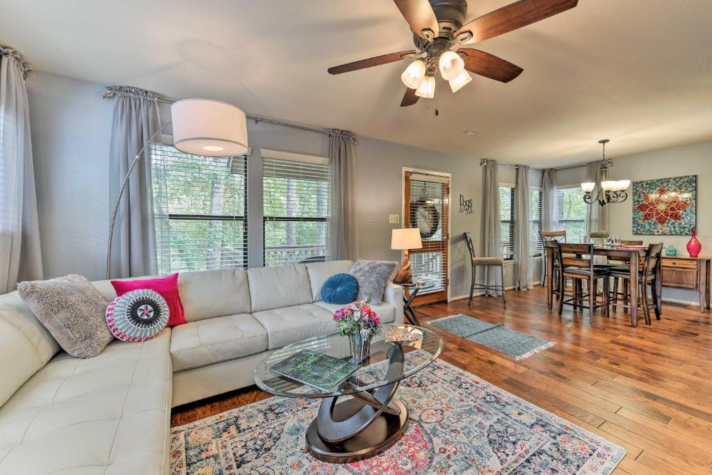 a living room with a couch and a table at Cozy Woodlands Townhome with Deck Near Market Street in The Woodlands