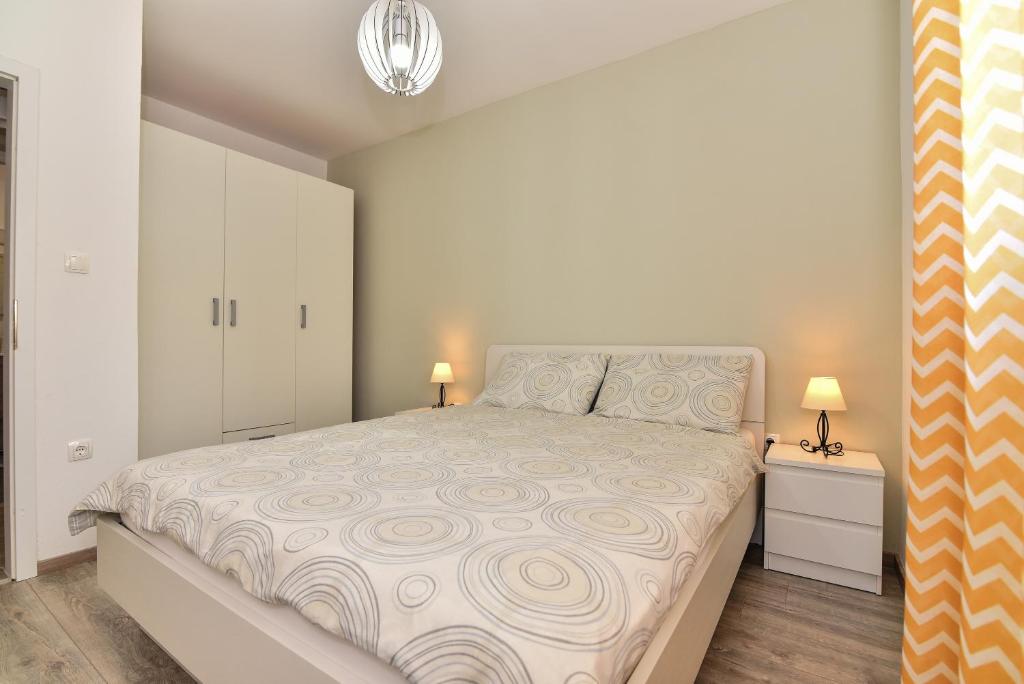 Posteľ alebo postele v izbe v ubytovaní Nova Apartments