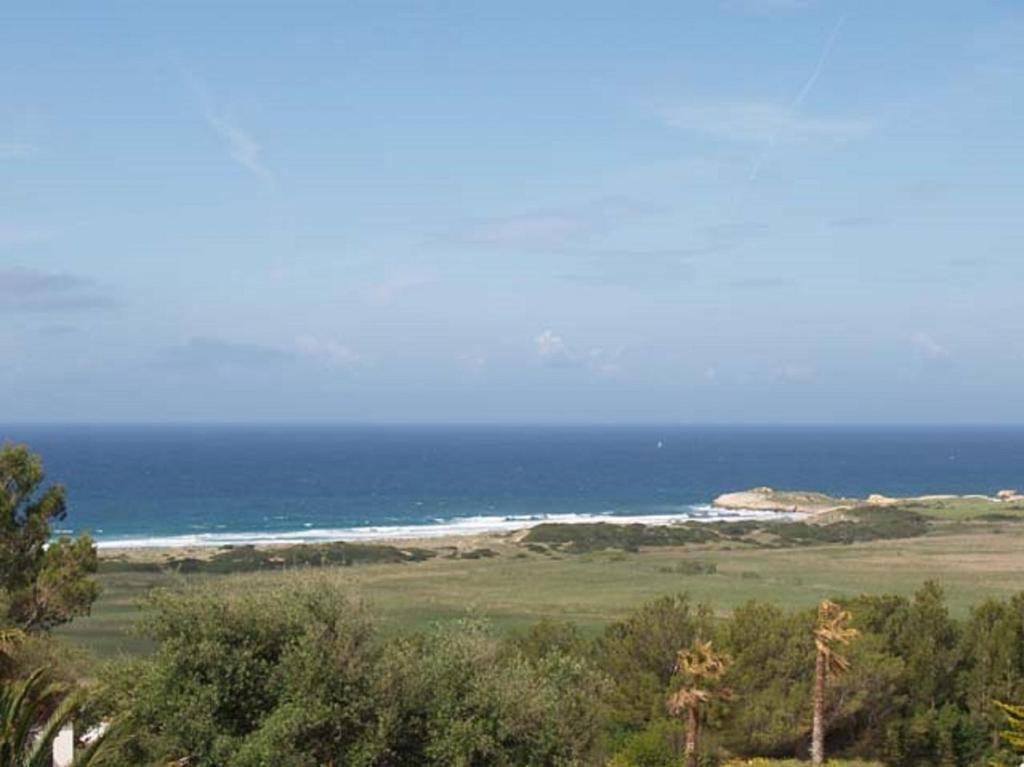 a view of a beach with the ocean in the background at Apartamento las camelias 18 in Alaior