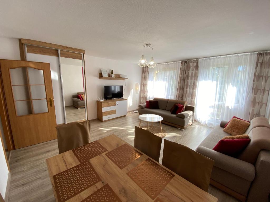 a living room with a couch and a table at APARTAMENT MARTYNKA in Szklarska Poręba