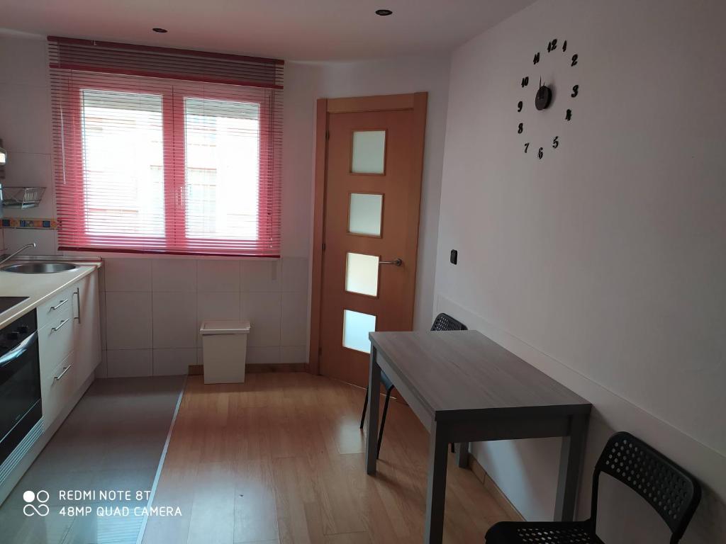 a kitchen with a wooden table and a dining room at Vianatxiki in Viana