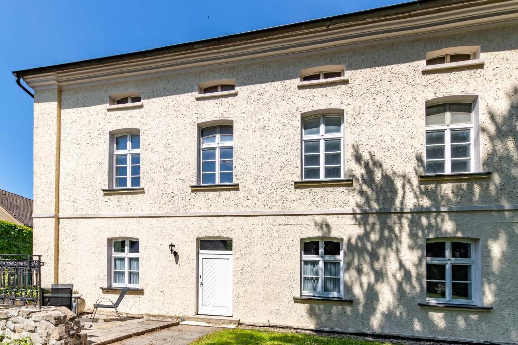 a large brick building with windows and a white door at Edelburg 3 - Ferienwohnung in Hemer