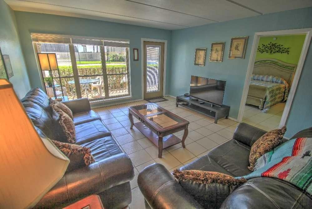 a living room with a couch and a table at Beachview 105 Condominium Condo in South Padre Island