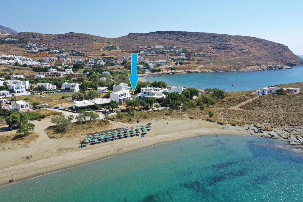 an aerial view of a beach with a blue arrow at Nostos Beachfront Apartments & Studios in Agios Ioannis Tinos