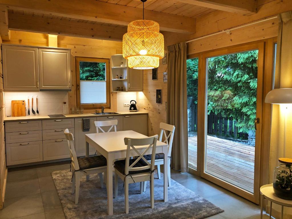 a kitchen with a table and chairs and a dining room at Regle House in Zakopane