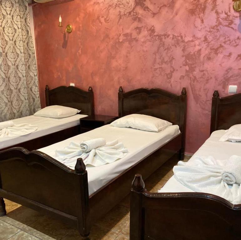 - 2 lits dans une chambre aux murs roses dans l&#39;établissement Hotel Jiul, à Eforie Sud