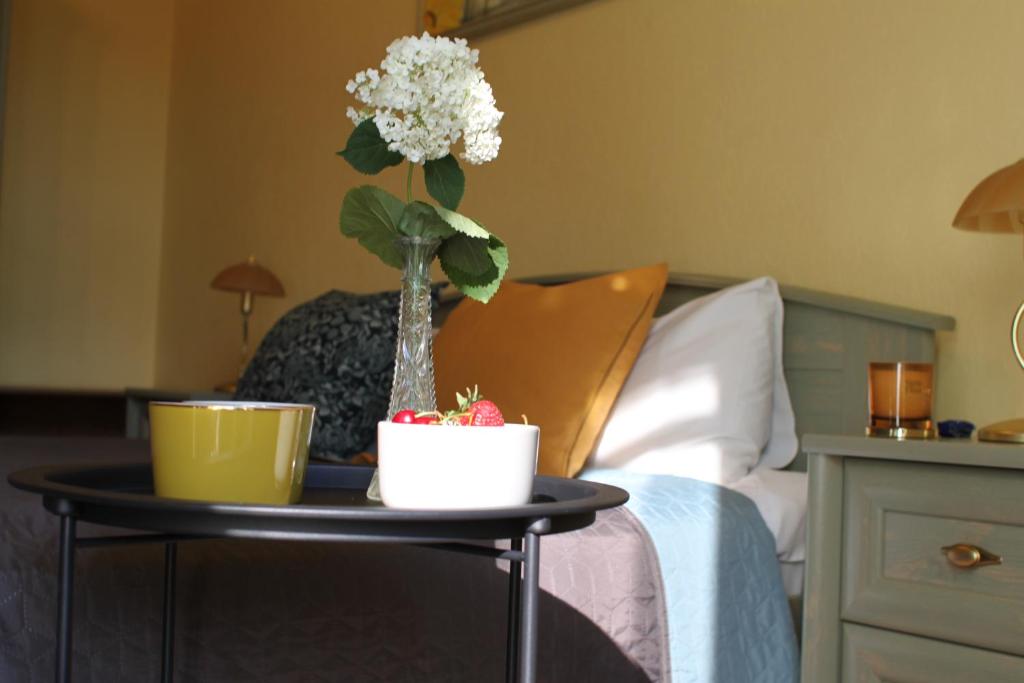 a table with a vase with flowers on top of a bed at Sunflower B&B in Kyiv