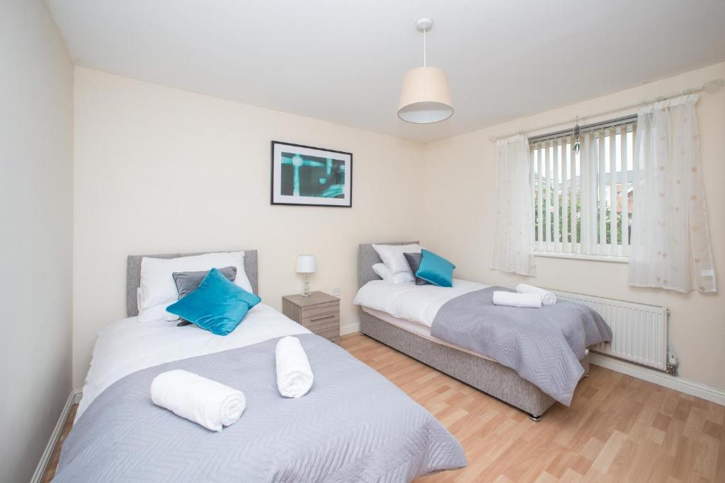 a bedroom with two beds and a window at Sea Winnings Apartment South Shields in South Shields