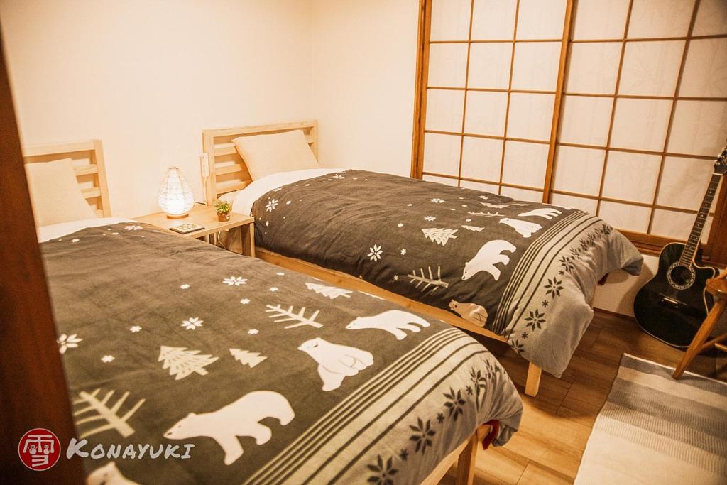Postel nebo postele na pokoji v ubytování KONAYUKI