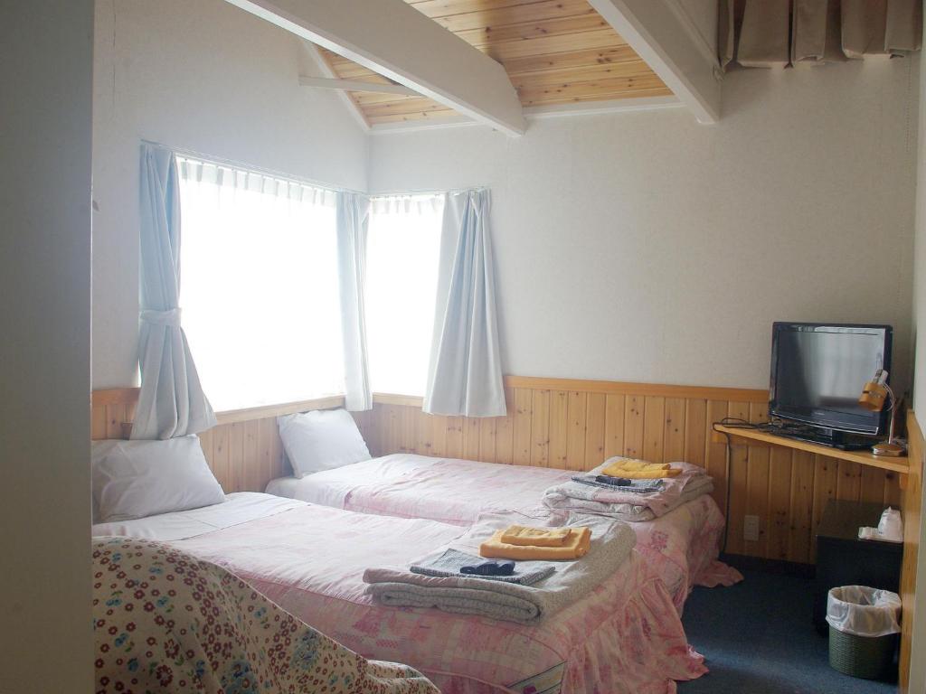 Ένα ή περισσότερα κρεβάτια σε δωμάτιο στο olive no sato vingh four eyes shodoshima / Vacation STAY 79057