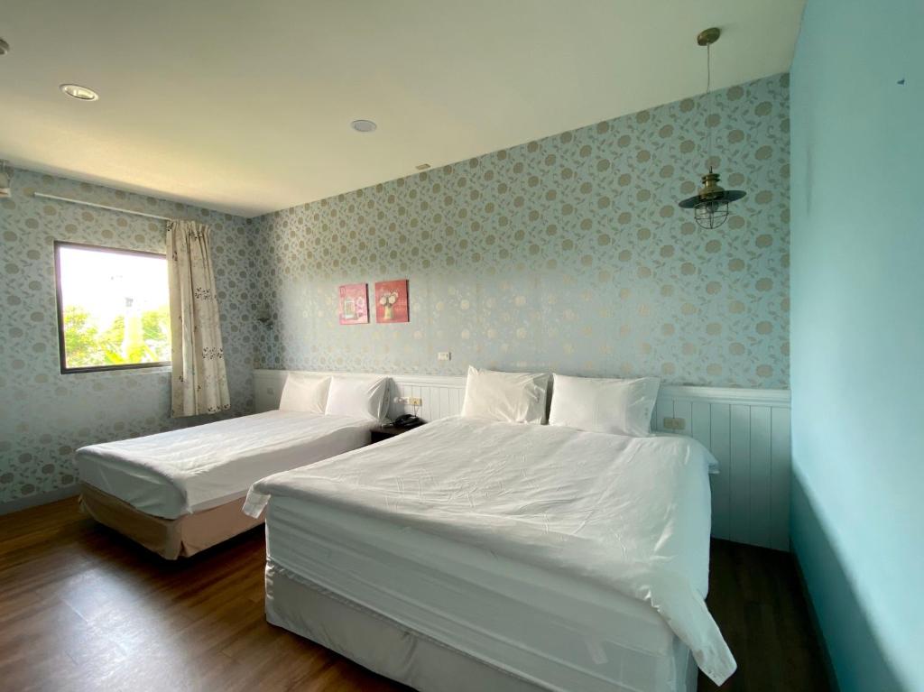 A bed or beds in a room at Lei Mi Er Hua Yuan Min Su