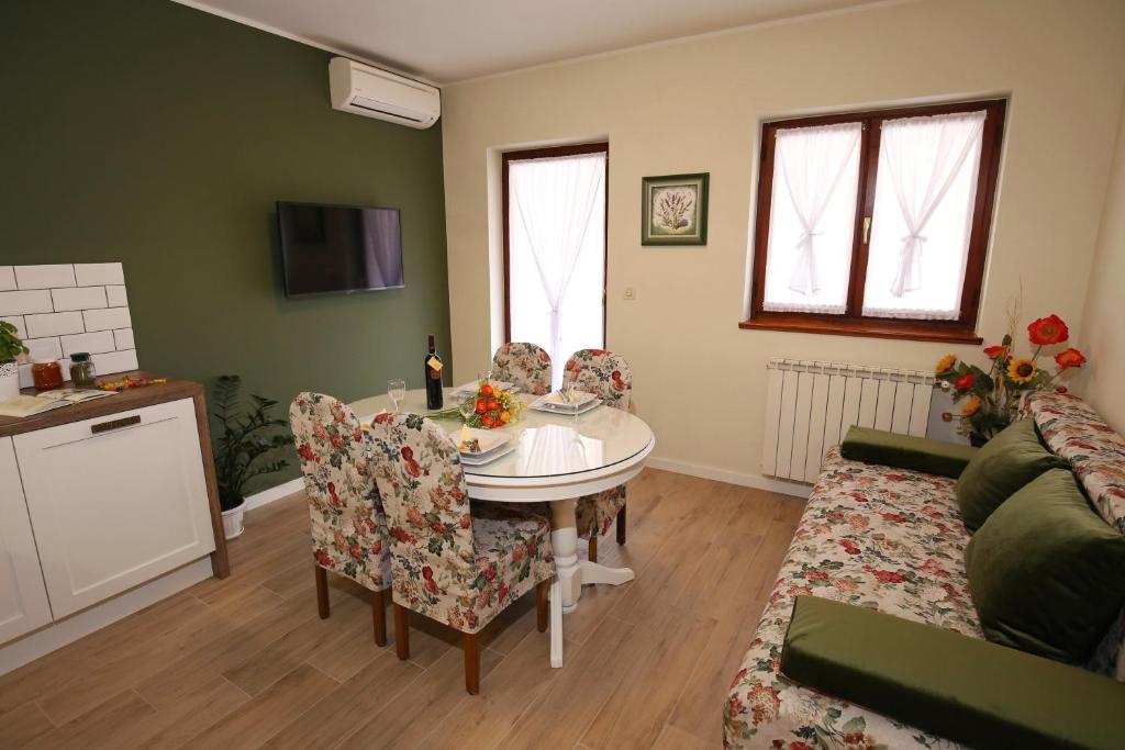 a living room with a table and chairs at Apartments Paola in Rovinj