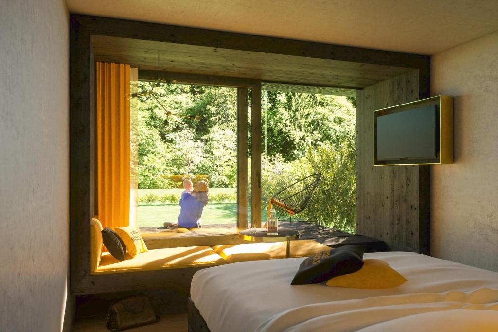 Postel nebo postele na pokoji v ubytování Prinz Rudolf Smart Hotel