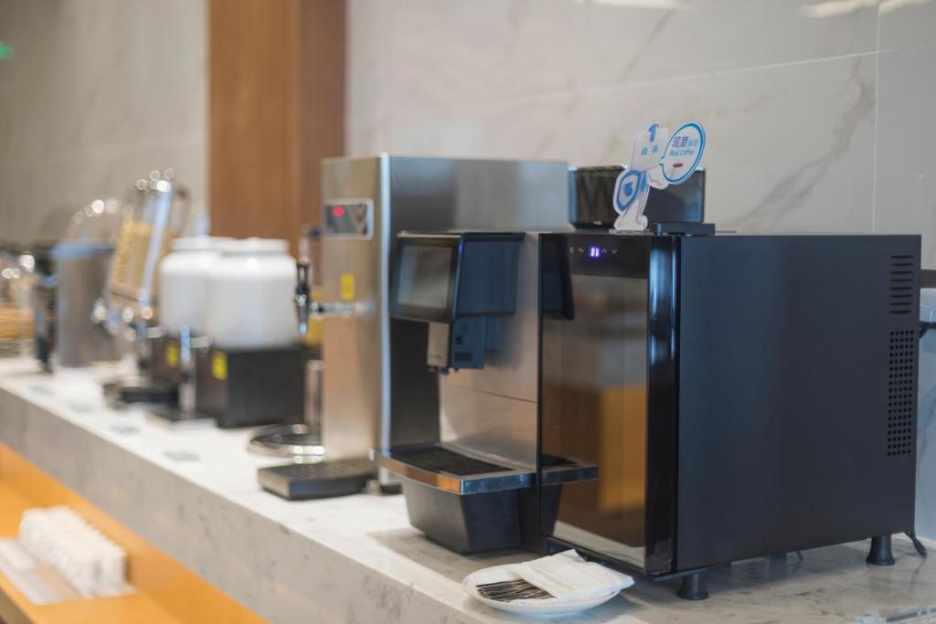 a counter with a coffee maker on it at Holiday Inn Express Qingdao Chengyang Central, an IHG Hotel in Qingdao