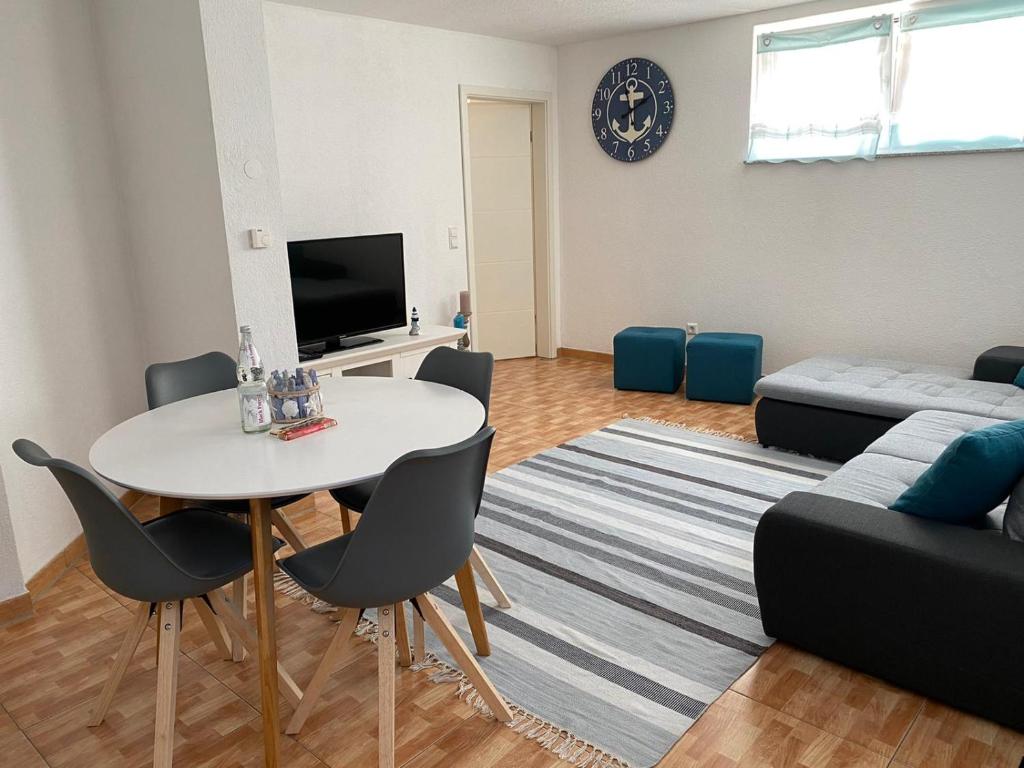 a living room with a table and a couch at Stiller Hafen in Herbolzheim