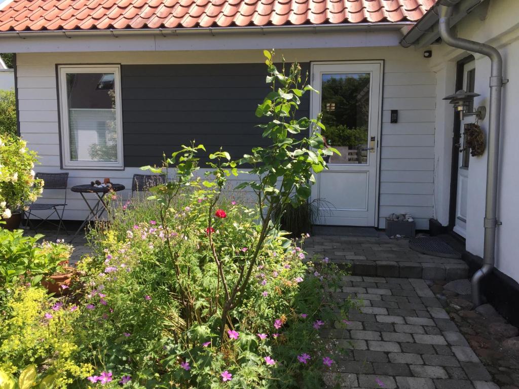 a house with a door and flowers in front of it at BB-Risskov in Risskov